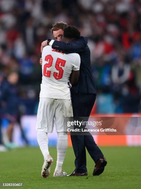 Bukayo Saka of England is consoled by Head Coach, Gareth Southgate after his penalty miss during the UEFA Euro 2020 Championship Final between Italy...