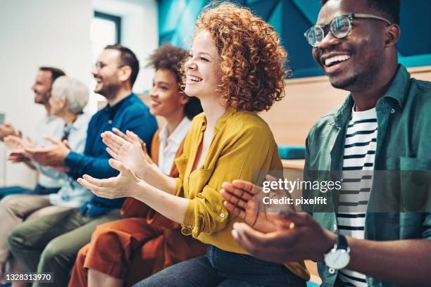 multi-ethnic group of business persons during a conference - congratulating 個照片及圖片檔