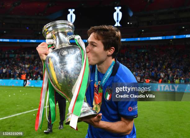 Federico Chiesa kisses The Henri Delaunay Trophy following his team's victory in the UEFA Euro 2020 Championship Final between Italy and England at...