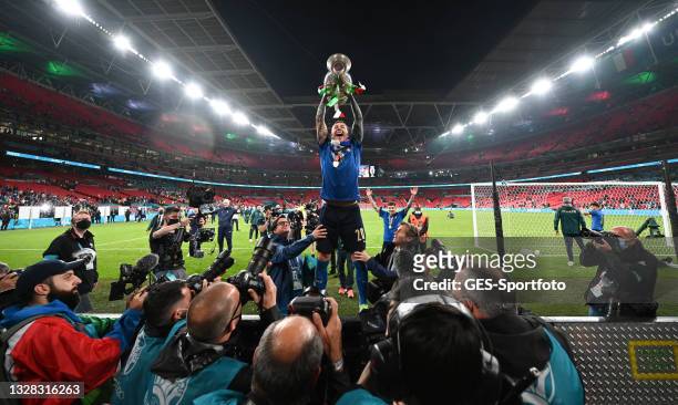 Federico Bernardeschi of Italy lifts the Henri Delaunay Trophy following his team's victory in during the UEFA Euro 2020 Championship Final between...