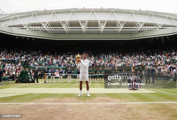 Novak Djokovic of Serbia celebrates with the trophy after winning his men's Singles Final match against Matteo Berrettini of Italy on Day Thirteen of...