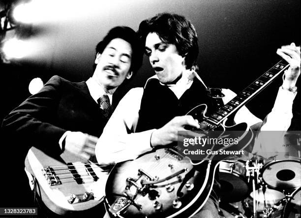 Charlie Tumahai & Bill Nelson of Be-Bop Deluxe perform on stage at Hammersmith Odeon, London, England, on February 26th, 1977.