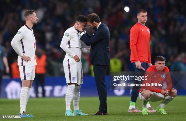 Gareth Southgate, Head Coach of England consoles Jadon Sancho following defeat in the UEFA Euro 2020 Championship Final between Italy and England at...