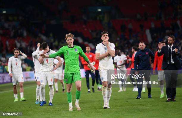 Jordan Pickford and Harry Maguire of England show their disappointment after defeat on penalties during the UEFA Euro 2020 Championship Final between...