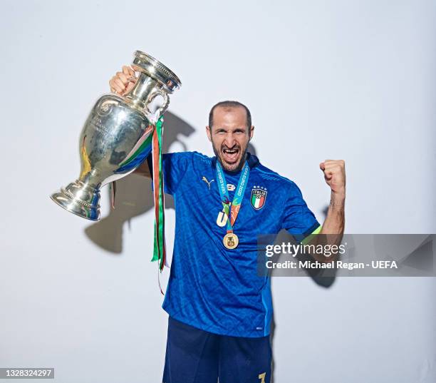 Giorgio Chiellini of Italy poses with The Henri Delaunay Trophy during an Italy Portrait Session following their side's victory in the UEFA Euro 2020...