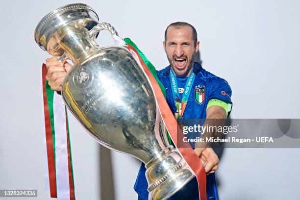 Giorgio Chiellini of Italy poses with The Henri Delaunay Trophy during an Italy Portrait Session following their side's victory in the UEFA Euro 2020...