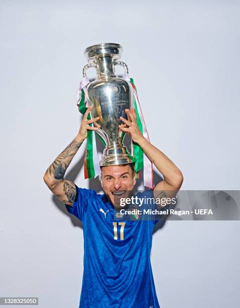 Ciro Immobile of Italy poses with The Henri Delaunay Trophy during an Italy Portrait Session following their side's victory in the UEFA Euro 2020...