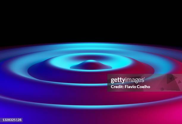concentric wave ripple lit by blue and pink lights - water ripple stockfoto's en -beelden