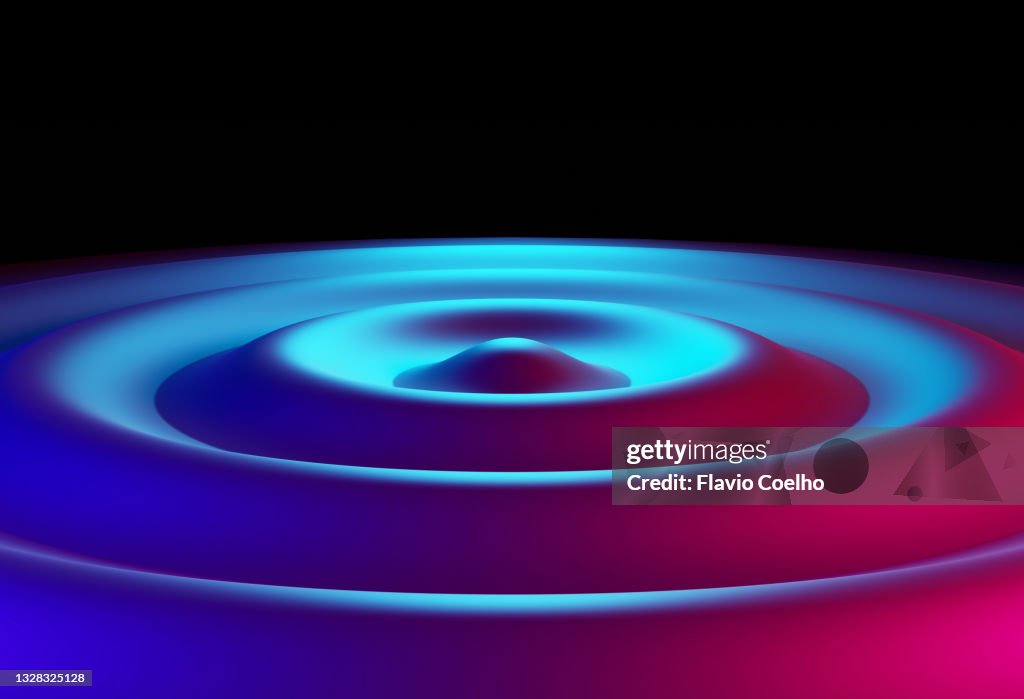 Concentric wave ripple lit by blue and pink lights