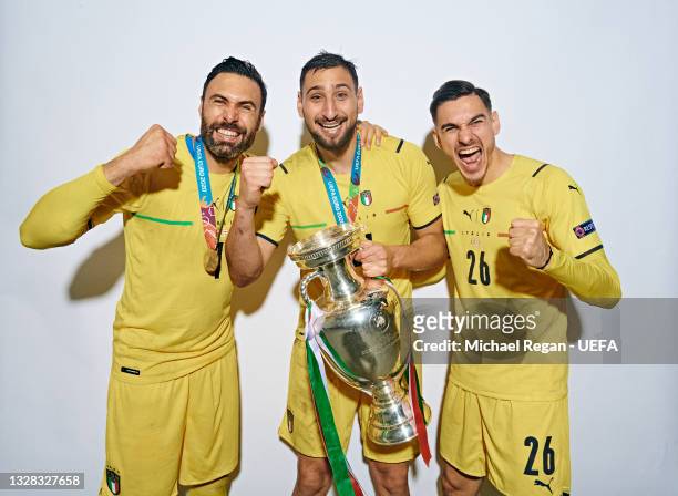 Salvatore Sirigu, Gianluigi Donnarumma and Alex Meret of Italy pose with The Henri Delaunay Trophy during an Italy Portrait Session following their...