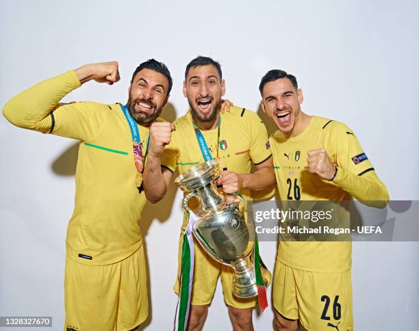 Salvatore Sirigu, Gianluigi Donnarumma and Alex Meret of Italy pose with The Henri Delaunay Trophy during an Italy Portrait Session following their...