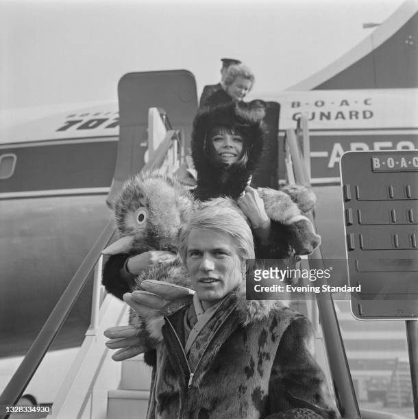 English singers Adam Faith and Sandie Shaw arrive at London Airport by air during their joint tour, UK, 29th March 1965. Faith introduced Shaw to his...