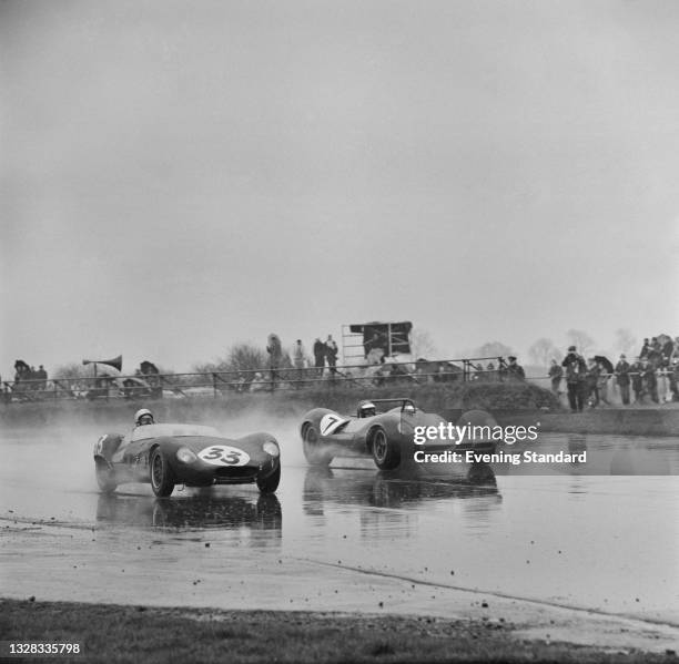 British racing drivers Robert 'Bobby' Bell in a Lola Mk.1 Climax and Jim Clark in a Lotus 30 Ford at the BARC Senior Service 200 International Race...