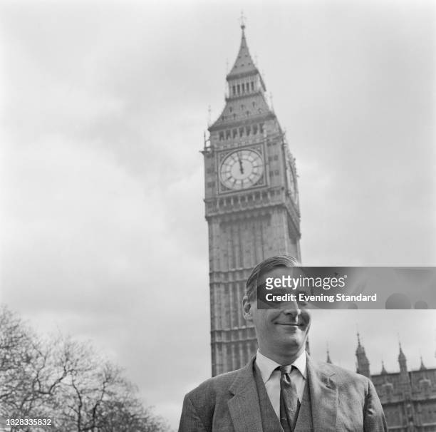 English Liberal politician Eric Lubbock in front of Big Ben, part of the Palace of Westminster in London, UK, 30th March 1965.