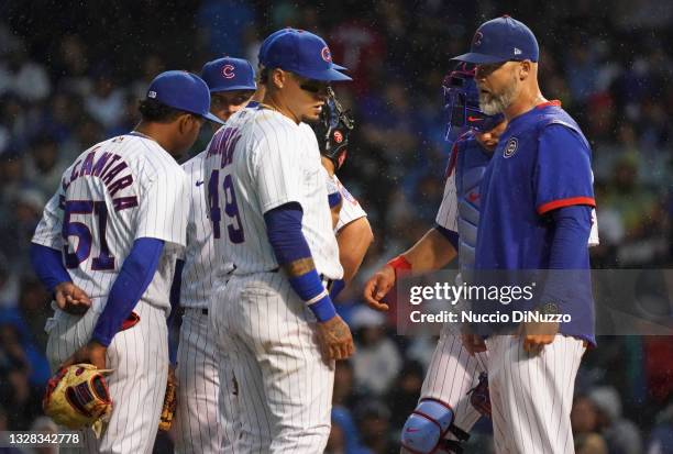 Manager David Ross of the Chicago Cubs visits the mound for a pitching change during the fifth inning of a game against the St. Louis Cardinals at...