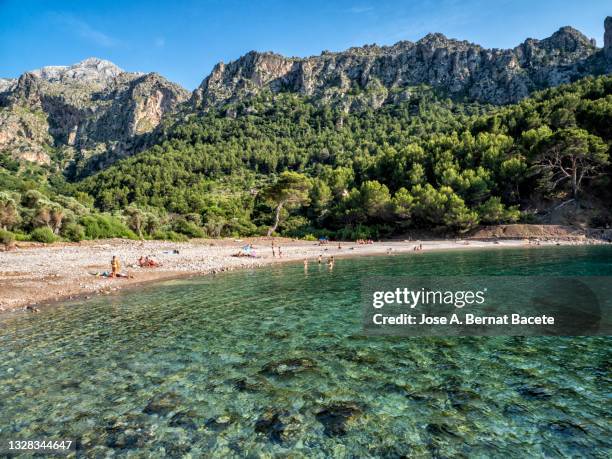 small sandy beach between mountains on the island of majorca. cala tuent. - sierra de tramuntana stock pictures, royalty-free photos & images