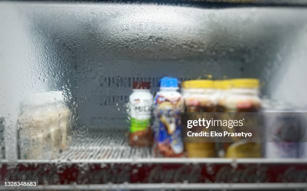 water bottle in a refrigerator glass - beverage fridge stock pictures, royalty-free photos & images