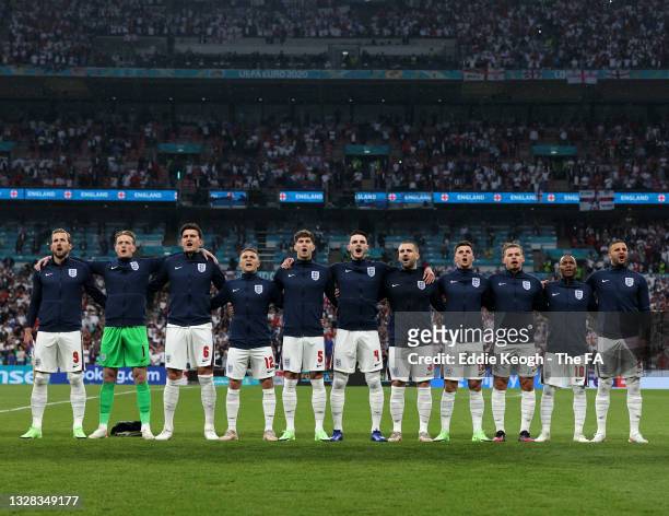 Players of England stand to sing the national anthem prior to the UEFA Euro 2020 Championship Final between Italy and England at Wembley Stadium on...