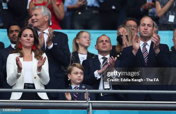 Catherine, Duchess of Cambridge, Prince George of Cambridge and Prince William, Duke of Cambridge and President of the Football Association applaud...