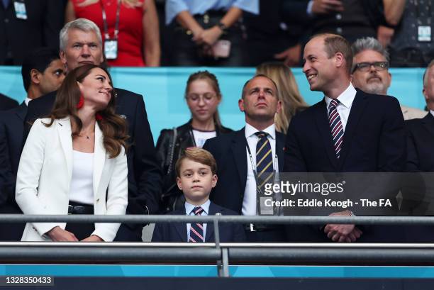 Catherine, Duchess of Cambridge, Prince George of Cambridge and Prince William, Duke of Cambridge and President of the Football Association look on...
