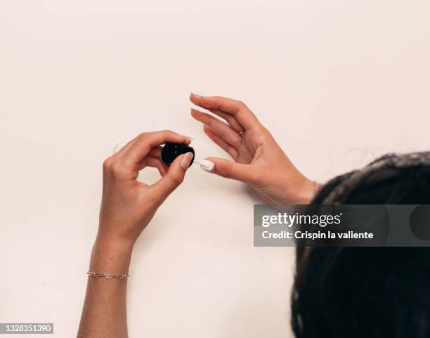 point of view of teenage girl painting her nails at home - white nail polish stock pictures, royalty-free photos & images