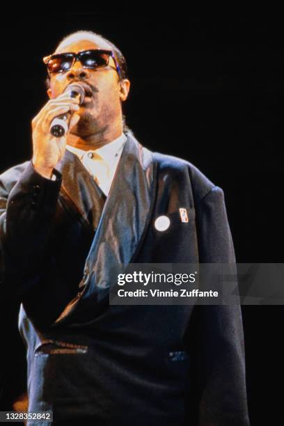 American singer, songwriter and musician Stevie Wonder performs at Wembley Stadium in London for the Nelson Mandela 70th Birthday Tribute Concert,...