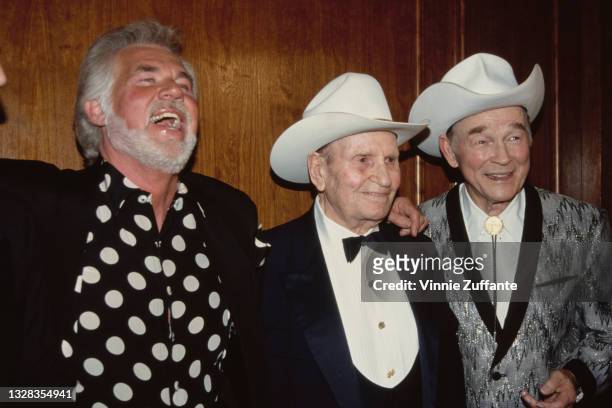 From left to right, American singer and songwriter Kenny Rogers with singers and actors Gene Autry and Roy Rogers at a press conference held by Autry...
