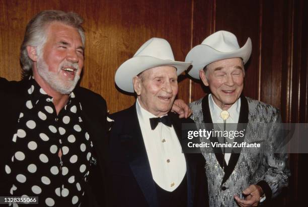 From left to right, American singer and songwriter Kenny Rogers with singers and actors Gene Autry and Roy Rogers at a press conference held by Autry...