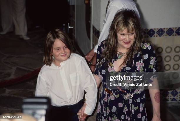 American singer, artist and poet Exene Cervenka, lead singer of punk rock band X, with her son Henry Blake Mortensen at the premiere of 'G.I. Jane'...