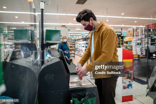 using self service till at supermarket - self service stock pictures, royalty-free photos & images