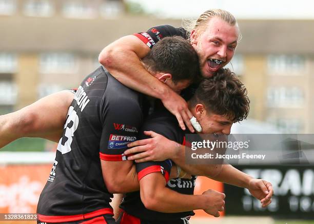 Oliver Leyland of London Broncos celebrates his side's sixth try with James Meadows of London Broncos and Josh Hodson of London Broncos during the...