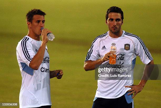 Gonzalo Higuain and Germand Denis drink some water during the scouting of the Estadio Metropolitano Roberto Melendez prior to the match of tomorrow...