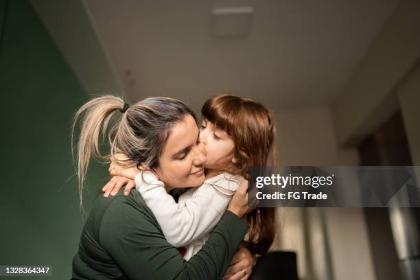 mother and daughter embracing at home - family at home stock pictures, royalty-free photos & images