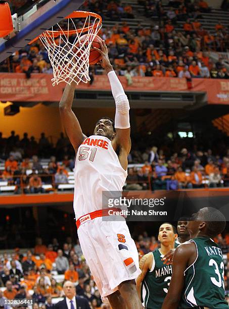 Fab Melo of the Syracuse Orange dunks the ball during the game against the Manhattan College Jaspers during the NIT Season Tip-off game at the...