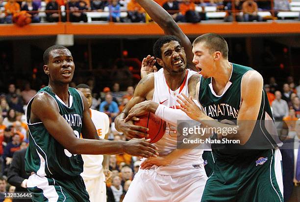 Fab Melo of the Syracuse Orange fights for the rebound against Donovan Kates, Ryan McCoy and George Beamon of the Manhattan College Jaspers during...