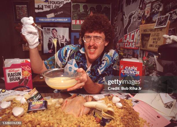 Portrait of American musician, parodist, and comedian Weird Al Yankovic as he poses with various food items during a photo shoot, March 20, 1984 in...