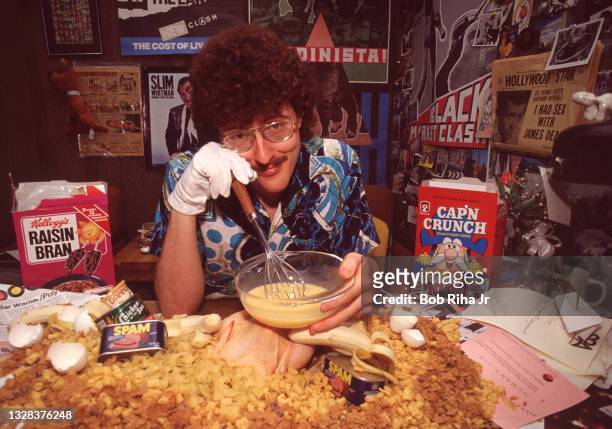 Portrait of American musician, parodist, and comedian Weird Al Yankovic as he poses with various food items during a photo shoot, March 20, 1984 in...