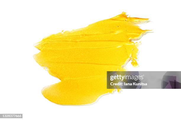 golden stroke of paint, nail polish on white background isolated. cosmetic products. makeup. - lip gloss smudge stock-fotos und bilder