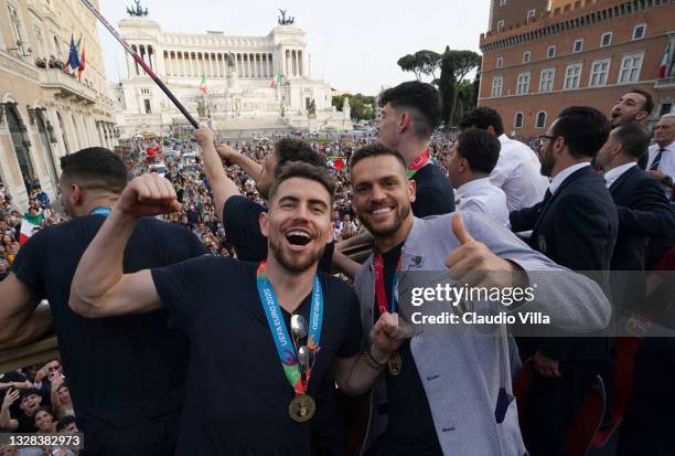 Leonardo Spinazzola and Rafael Toloi of Italy celebrate during Italy's national men’s football team open-top bus victory parade, a day after Italy...