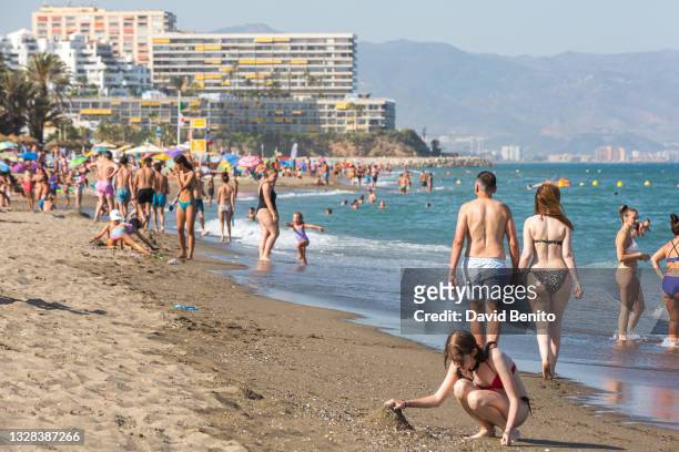 People enjoy the hot weather at the beach on July 12, 2021 in Torremolinos, Málaga, Spain. Malaga currently sees a yellow warning for temperatures...