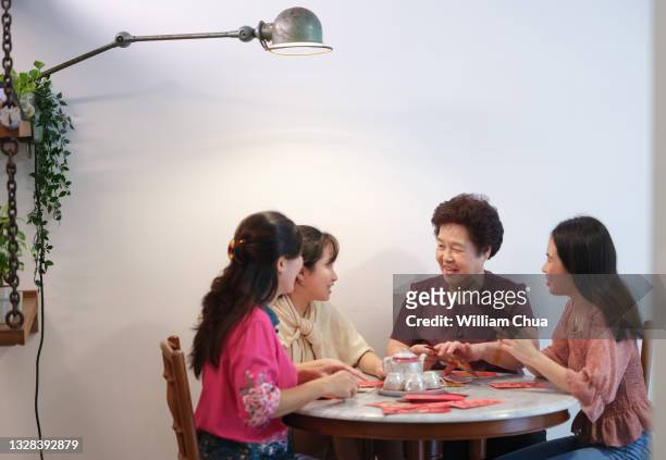 putting money in red packet for chinese new year - chinese prepare for lunar new year stock pictures, royalty-free photos & images