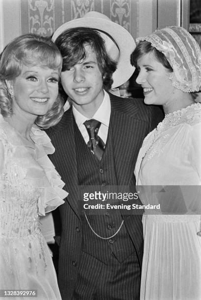 From left to right, American actress and singer Debbie Reynolds with her son Todd Fisher and daughter Carrie Fisher , UK, 31st July 1974. Reynolds is...