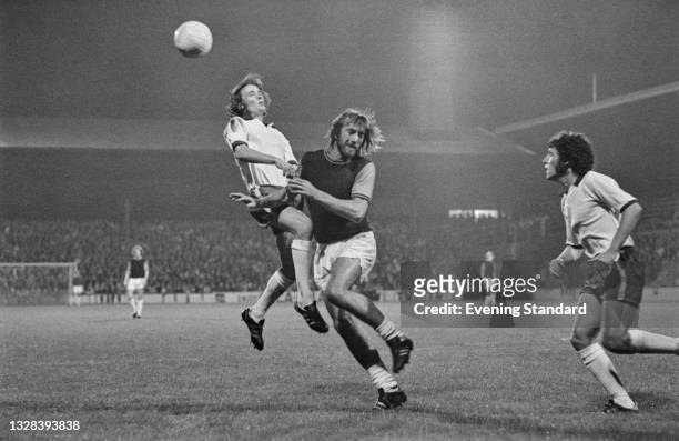 English footballer Billy Bonds of West Ham United and Ray Mathias of Tranmere Rovers during a League Cup 2nd round replay at Upton Park in London,...