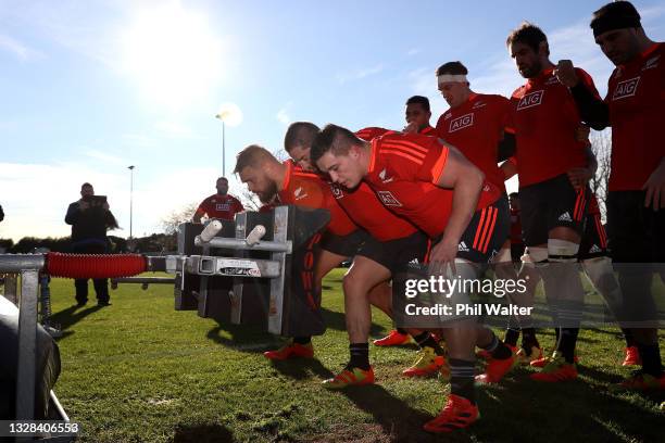 The New Zealand All Blacks front row practice the scrum during a training session at Beetham Park on July 13, 2021 in Hamilton, New Zealand.