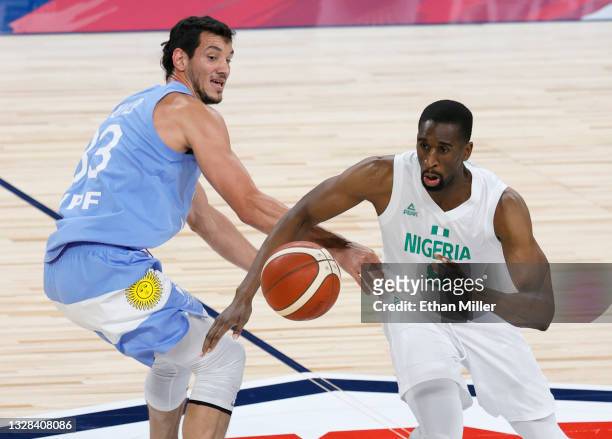 Ekpe Udoh of Nigeria brings the ball up the court against Tayavek Gallizzi of Argentina during an exhibition game at Michelob ULTRA Arena ahead of...