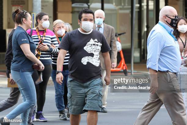 People walk through the CBD on July 13, 2021 in Brisbane, Australia. Queensland has recorded two new local COVID-19 cases overnight, but as the...