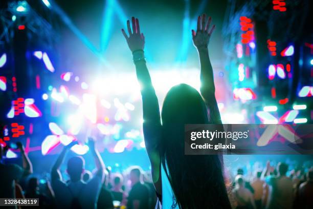 woman enjoying a concert party - concert lights stock pictures, royalty-free photos & images