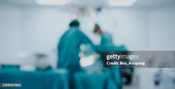 blurred image background of medical team performing surgical operation in operating room. - operating room - fotografias e filmes do acervo