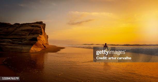 surfer enjoying the sunset in the shore, epic location - portugal beach stock pictures, royalty-free photos & images