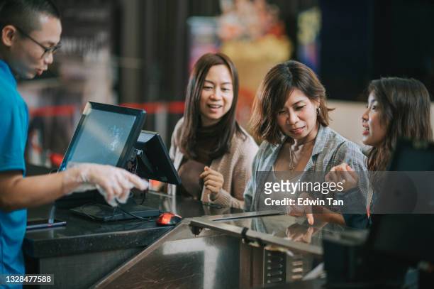 asian chinese women in front bar counter ordering snack popcorn before movie show time at movie theater cinema - movie counter stock pictures, royalty-free photos & images